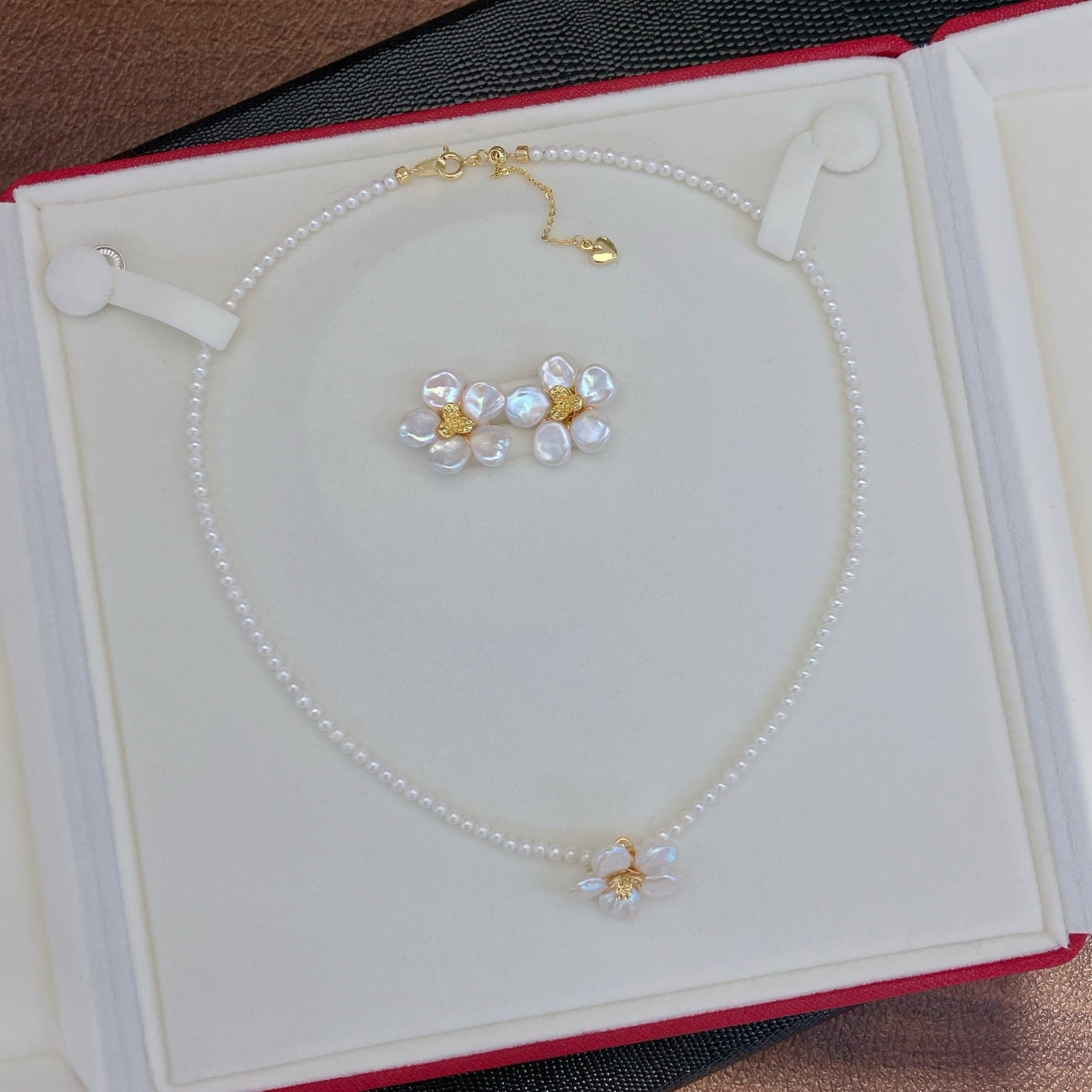 A handcrafted pearl necklace and earrings set featuring delicate petal designs and 3.5–4mm freshwater pearls, perfect for spring.