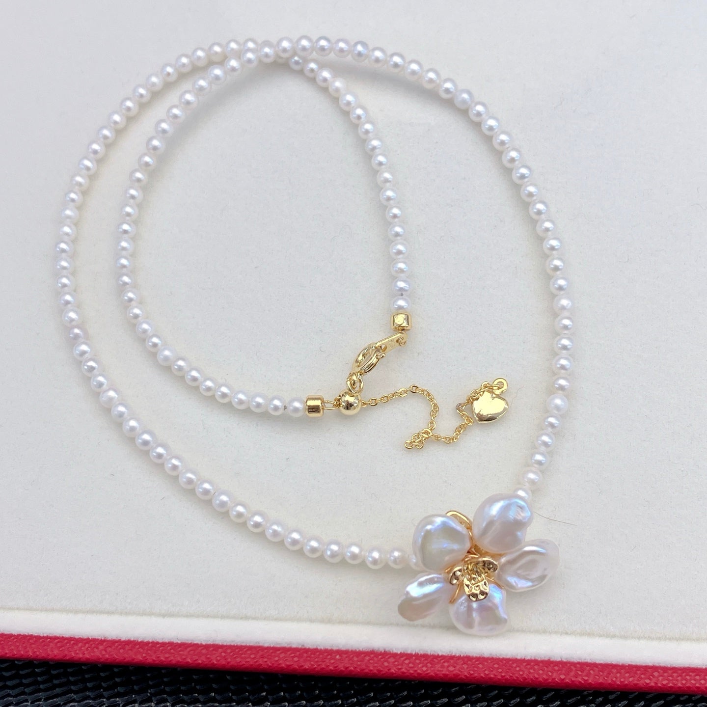 A handcrafted pearl necklace and earrings set featuring delicate petal designs and 3.5–4mm freshwater pearls, perfect for spring.