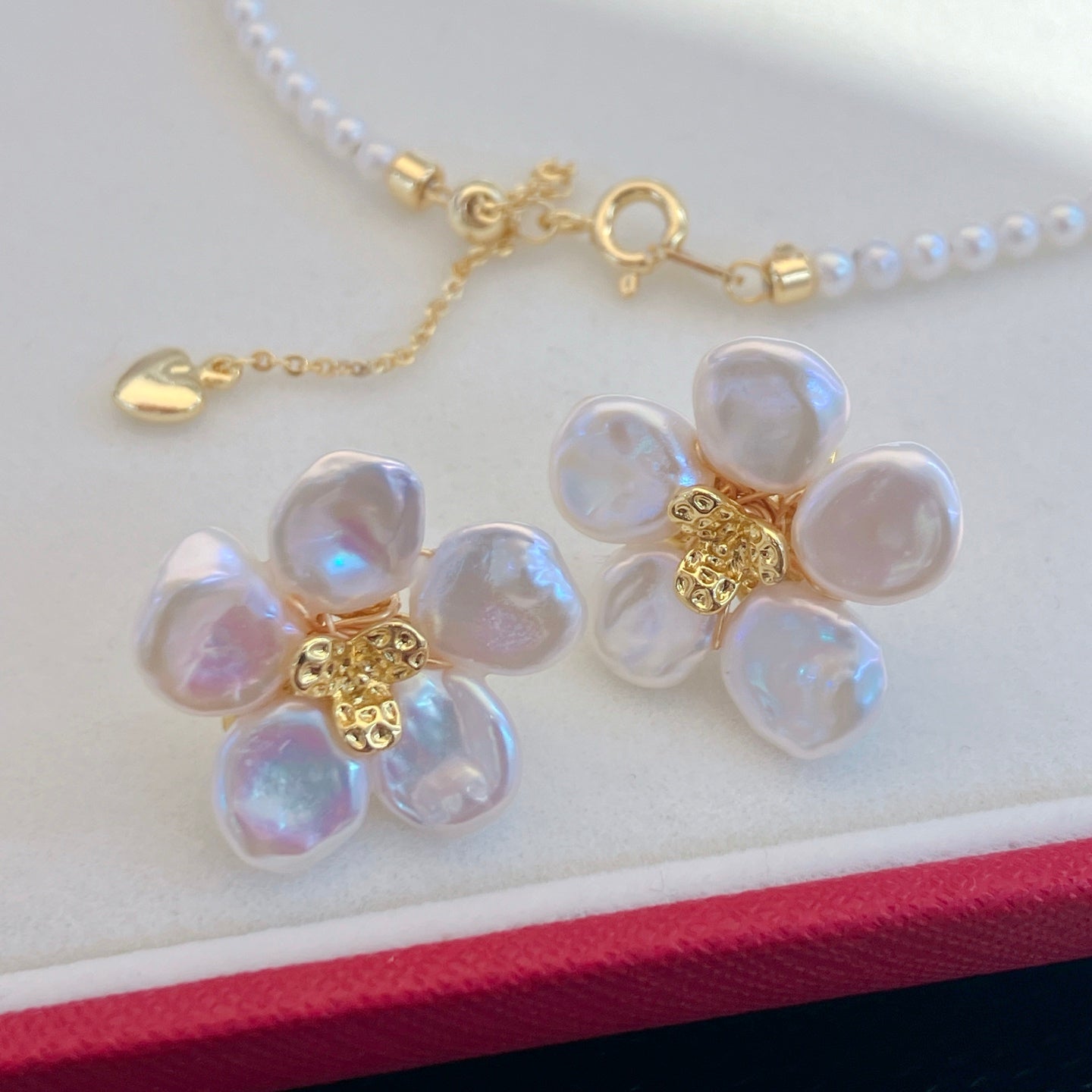 A handcrafted pearl necklace and earrings set featuring delicate petal designs and 3.5–4mm freshwater pearls, perfect for spring.