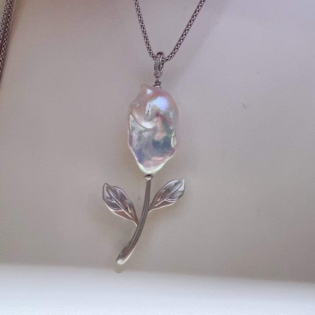 Vintage-inspired rose pendant with a textured sandblasted finish, designed for versatile styling.