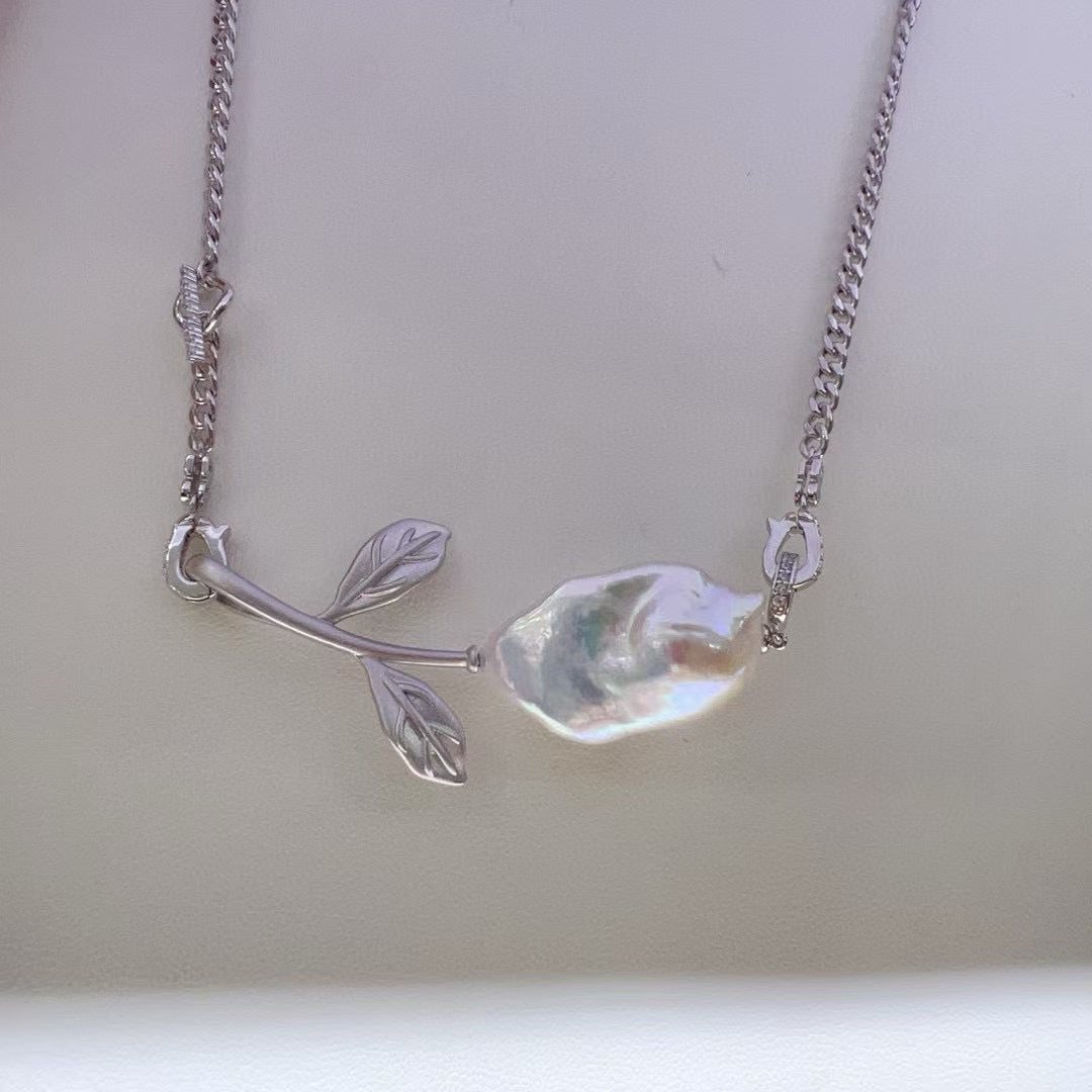 Vintage-inspired rose pendant with a textured sandblasted finish, designed for versatile styling.