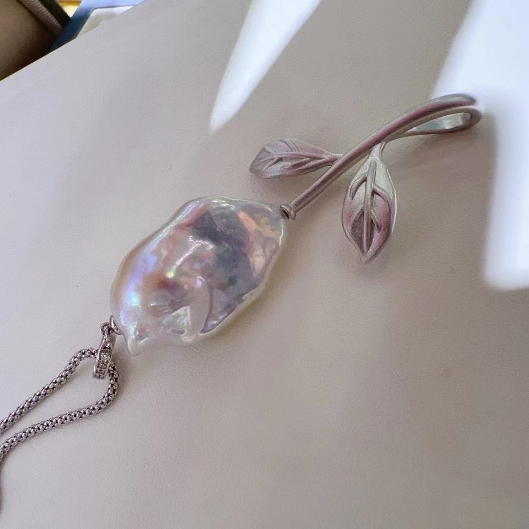 Vintage-inspired rose pendant with a textured sandblasted finish, designed for versatile styling.