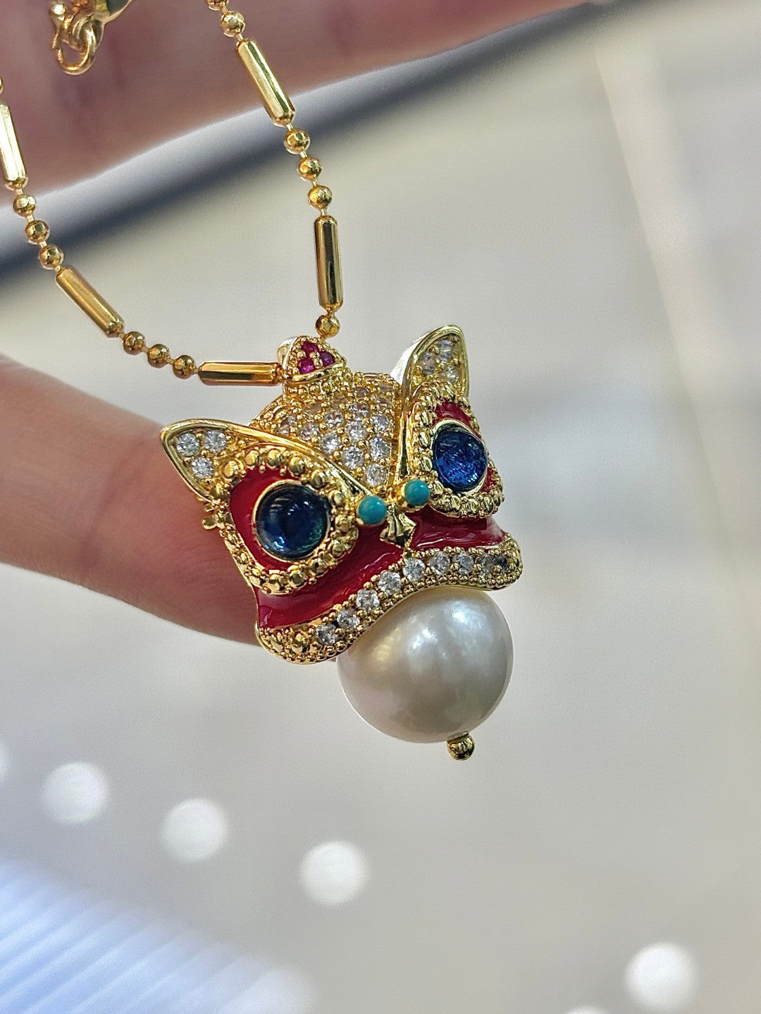 Chinese guardian lion brooch and pendant with Edison pearl, symbolizing luck, prosperity, and elegance.