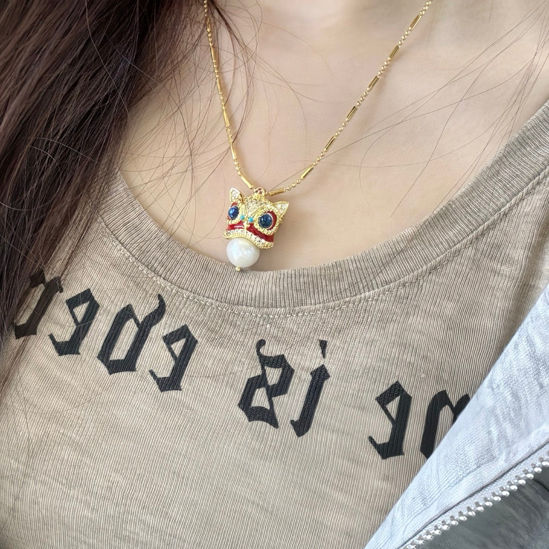 Chinese guardian lion brooch and pendant with Edison pearl, symbolizing luck, prosperity, and elegance.