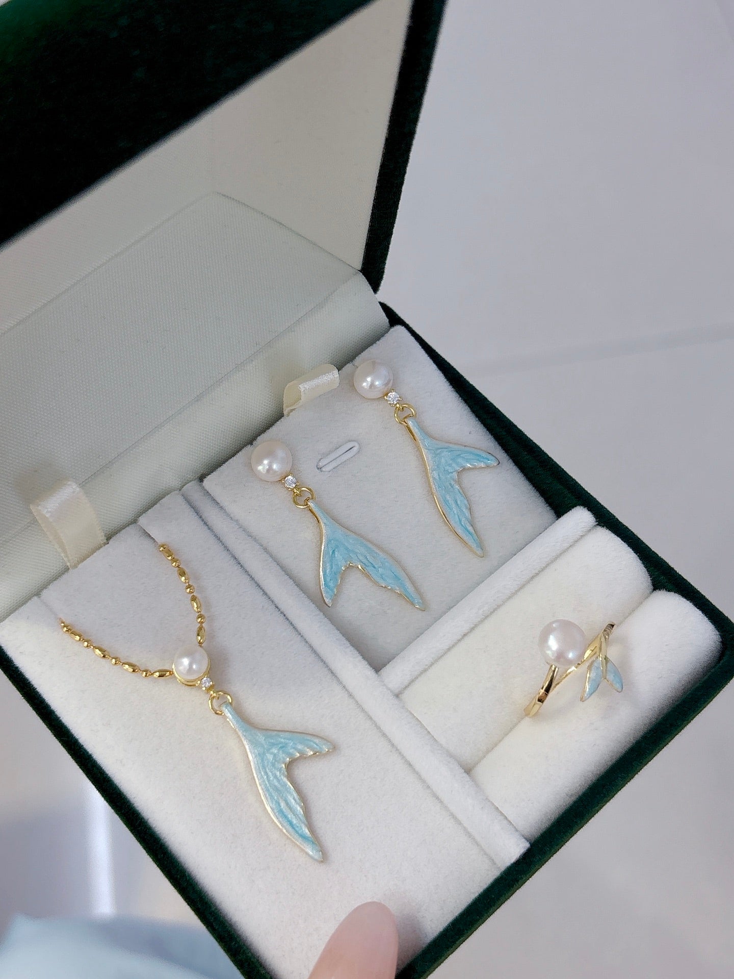 Mermaid pearl jewelry set with earrings, ring, and necklace featuring freshwater pearls and elegant fish-tail details.