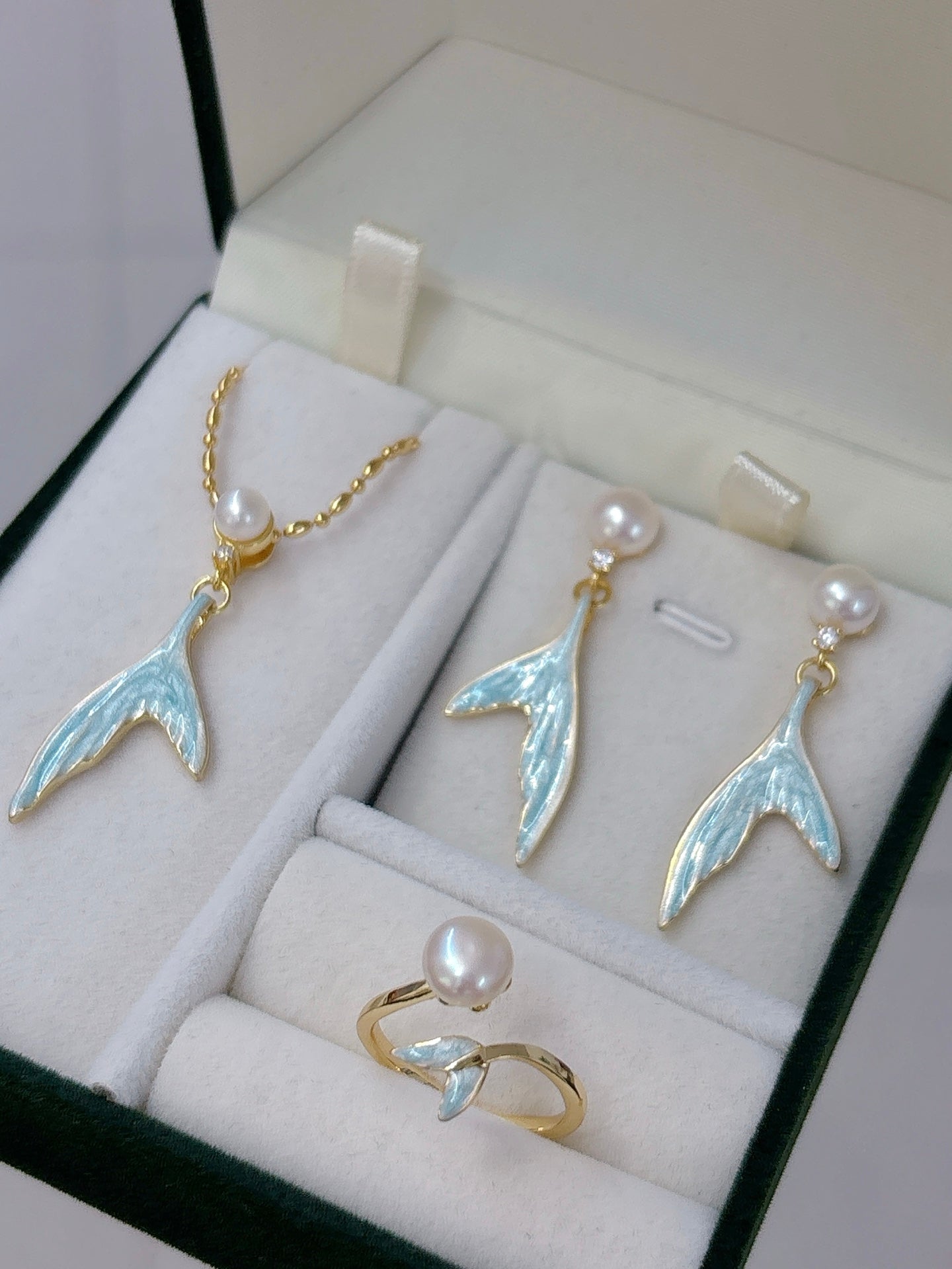 Mermaid pearl jewelry set with earrings, ring, and necklace featuring freshwater pearls and elegant fish-tail details.