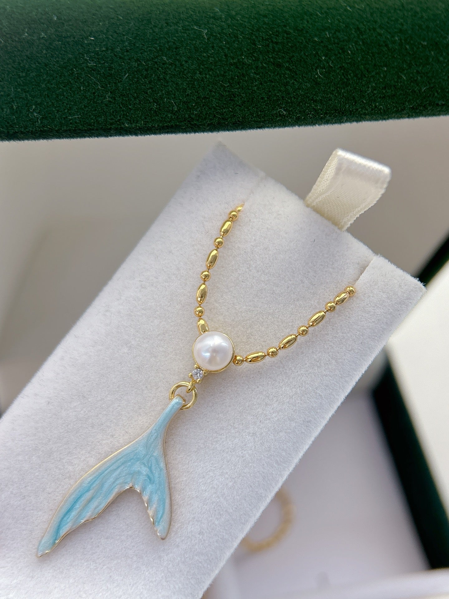 Mermaid pearl jewelry set with earrings, ring, and necklace featuring freshwater pearls and elegant fish-tail details.
