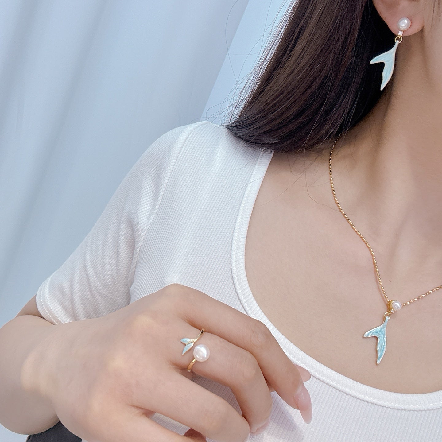 Mermaid pearl jewelry set with earrings, ring, and necklace featuring freshwater pearls and elegant fish-tail details.