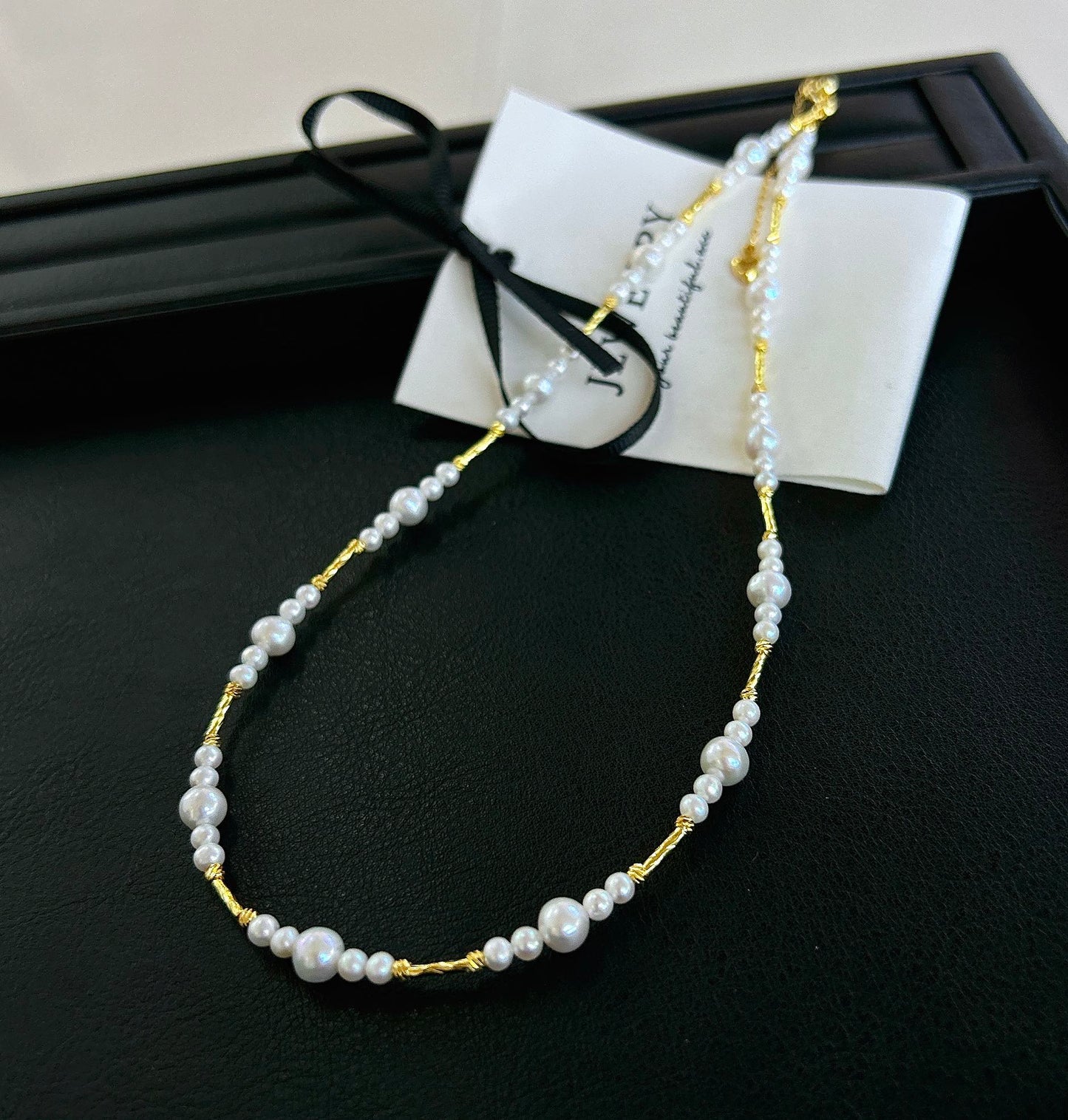 Gradient freshwater baby pearl necklace featuring 3–7mm pearls with adjustable clasp for a perfect fit.
