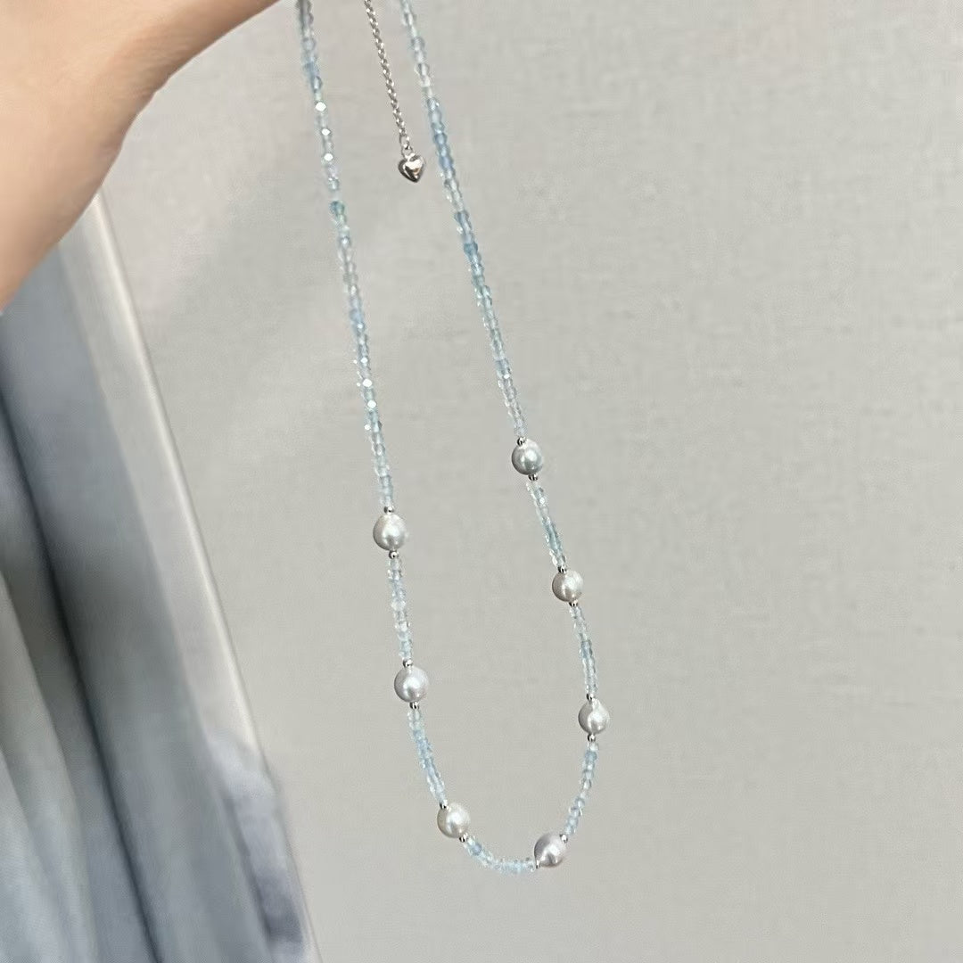 Sterling silver necklace featuring aquamarine stones and 6–7mm grey Akoya baroque pearls, elegant ocean-inspired jewelry.