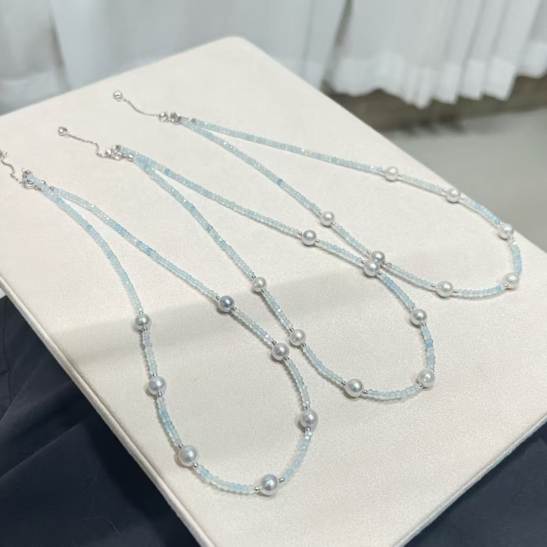 Sterling silver necklace featuring aquamarine stones and 6–7mm grey Akoya baroque pearls, elegant ocean-inspired jewelry.