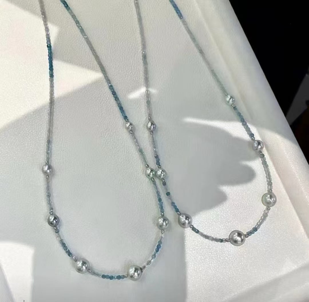 Sterling silver necklace featuring aquamarine stones and 6–7mm grey Akoya baroque pearls, elegant ocean-inspired jewelry.