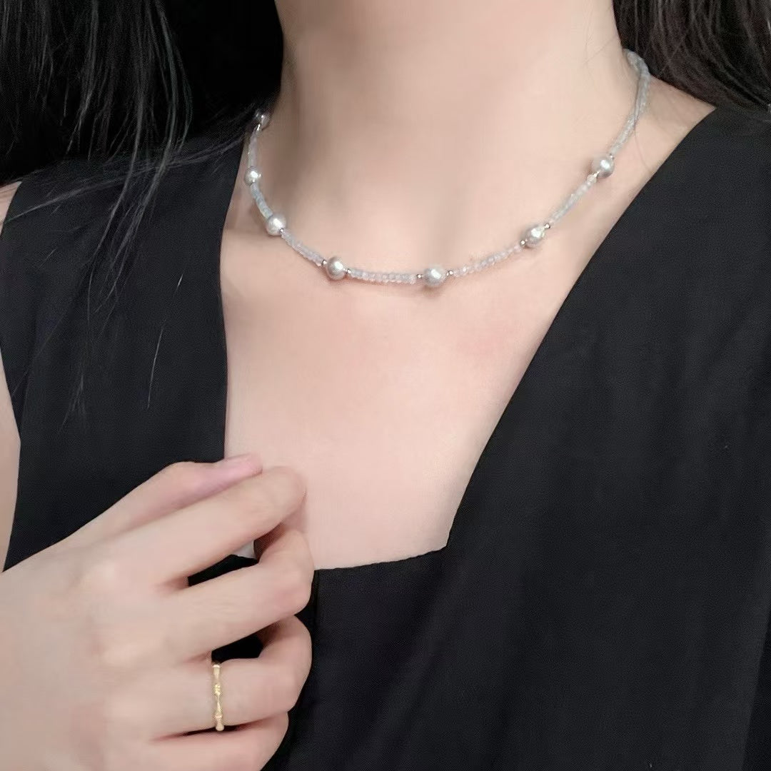 Sterling silver necklace featuring aquamarine stones and 6–7mm grey Akoya baroque pearls, elegant ocean-inspired jewelry.