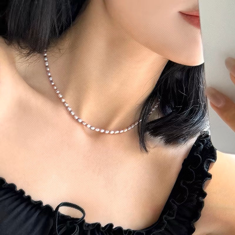 Gradient necklace featuring 3–4mm freshwater pearls fading from orange to purple, with sterling silver adjustable clasp.