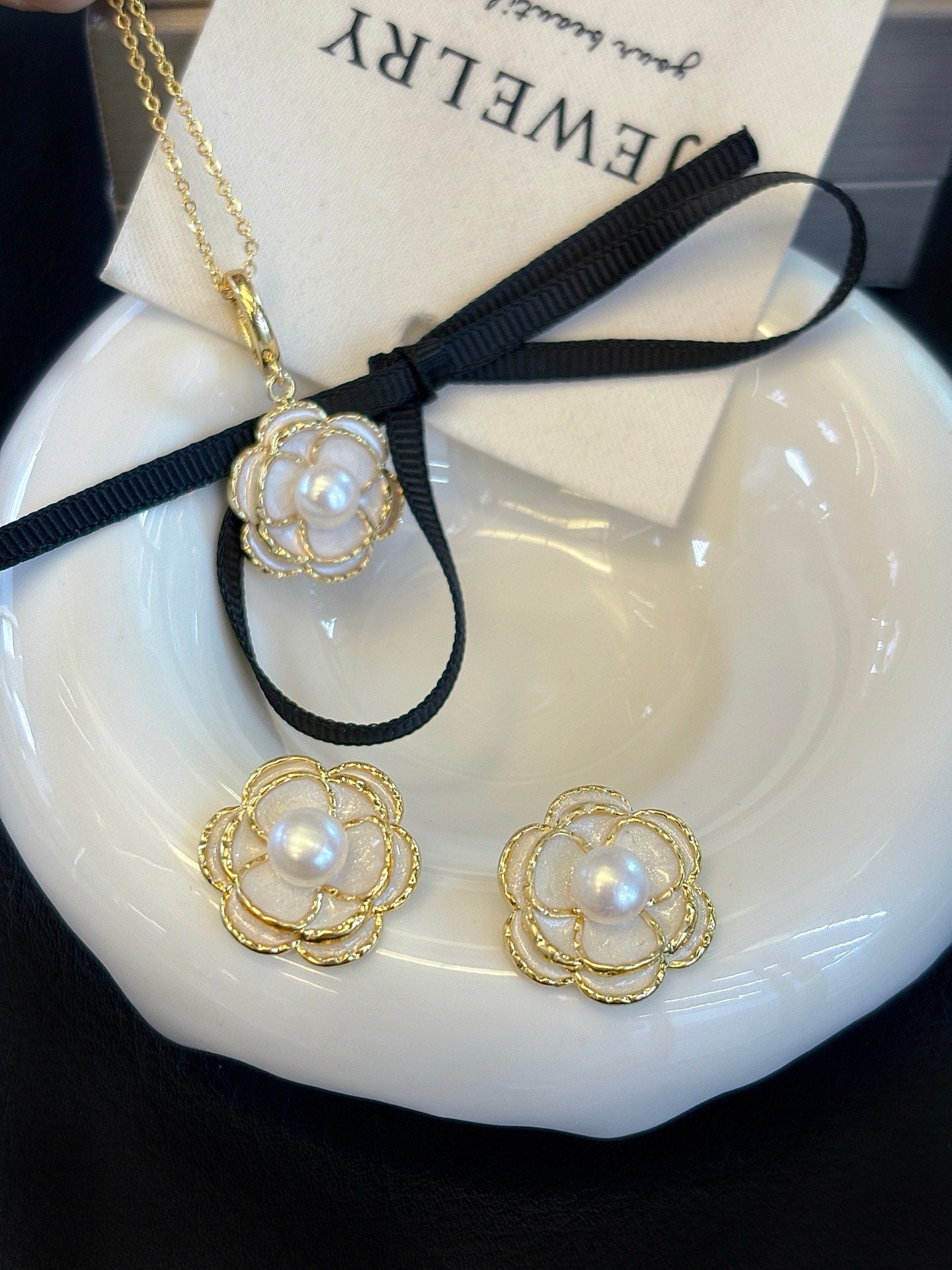 Vintage-style camellia pearl jewelry set featuring freshwater pearls and 14k gold-plated detailing.