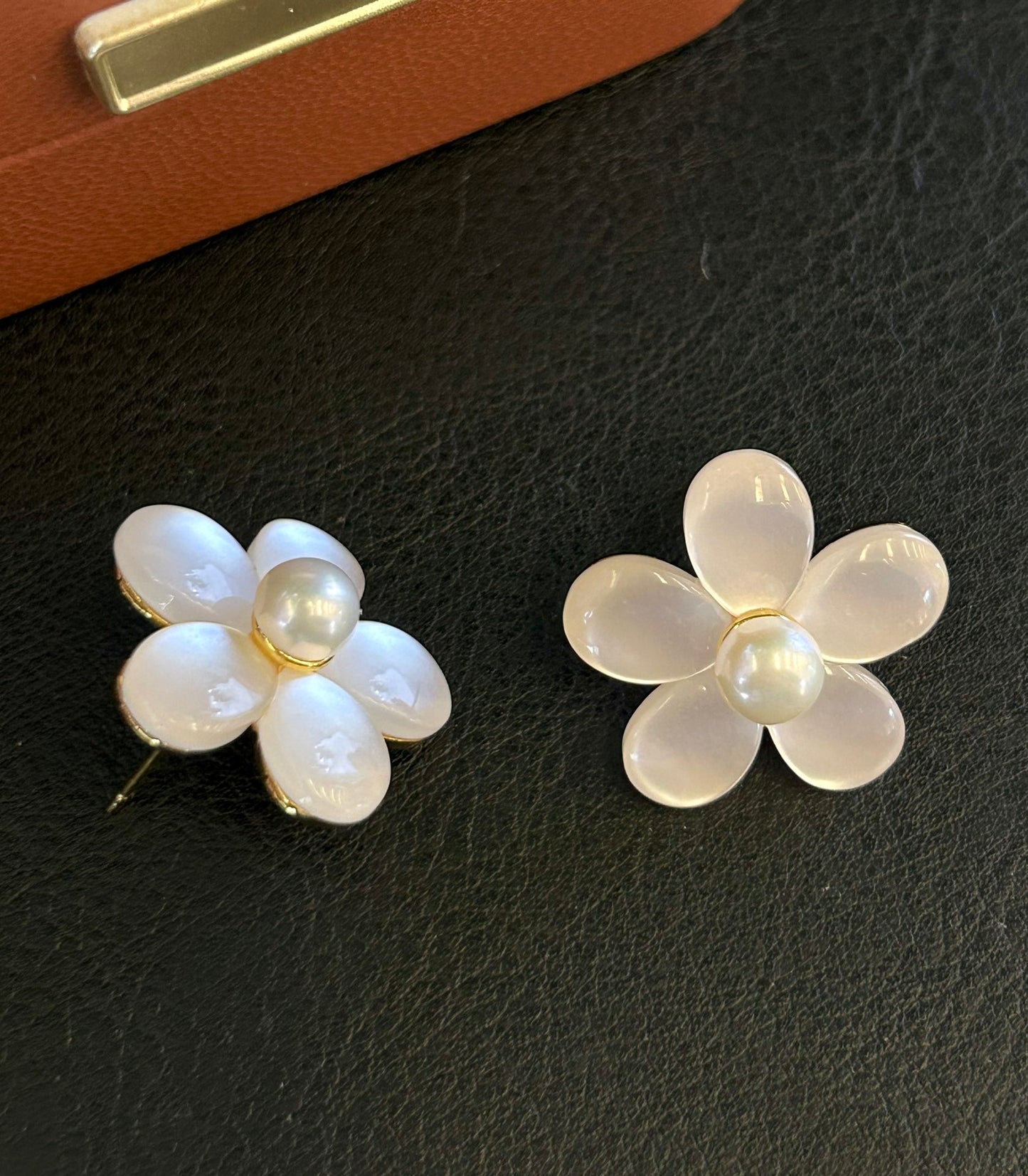Elegant pearl and cat’s eye floral stud earrings with sterling silver posts.