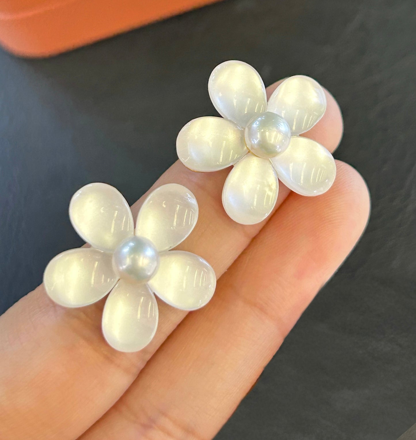 Elegant pearl and cat’s eye floral stud earrings with sterling silver posts.