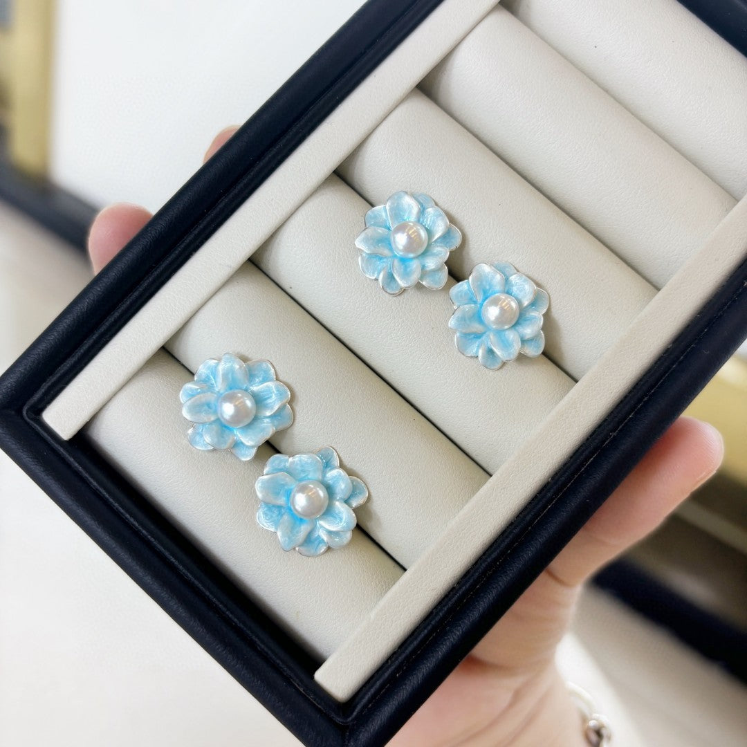 Ice blue floral pearl stud earrings with freshwater pearls and silver posts.