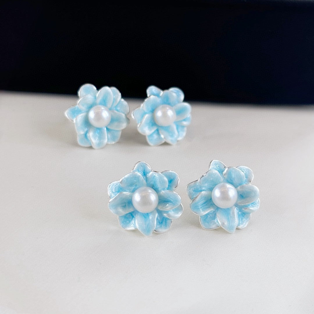 Ice blue floral pearl stud earrings with freshwater pearls and silver posts.