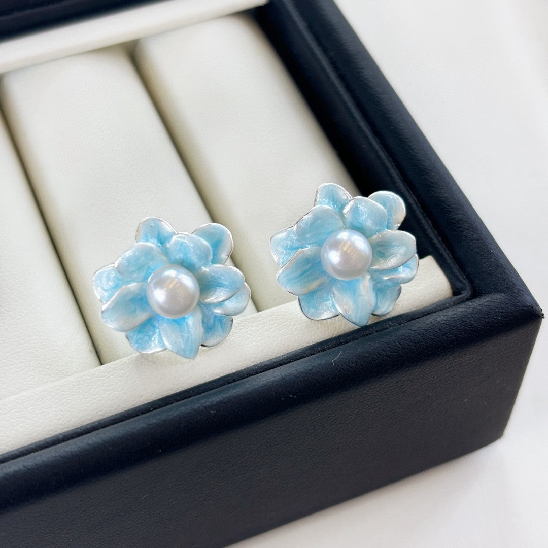 Ice blue floral pearl stud earrings with freshwater pearls and silver posts.