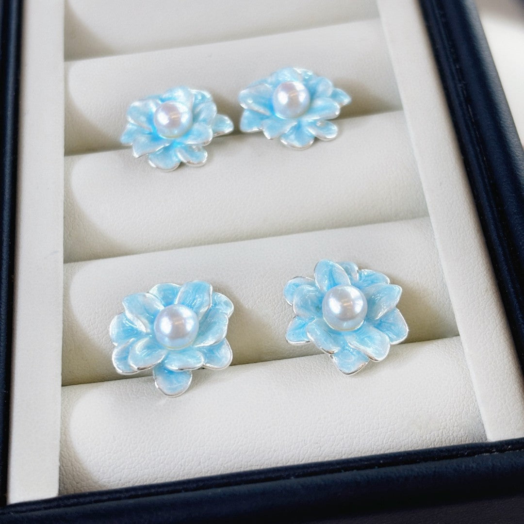 Ice blue floral pearl stud earrings with freshwater pearls and silver posts.