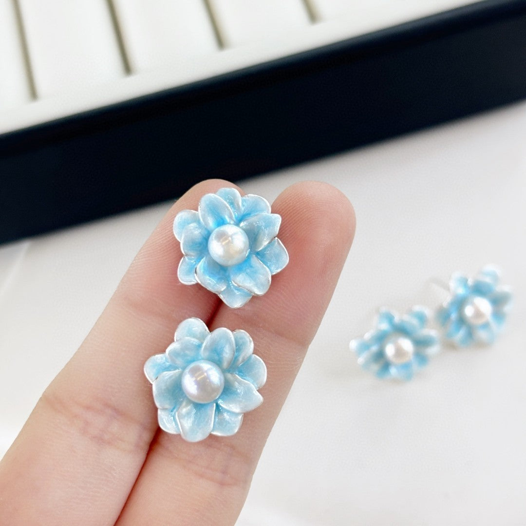 Ice blue floral pearl stud earrings with freshwater pearls and silver posts.