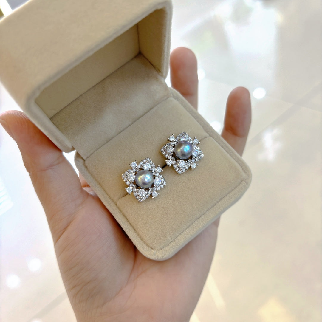 Elegant pearl jewelry set featuring four-leaf clover earrings, ring, and pendant with Akoya pearls and ice-crystal design.
