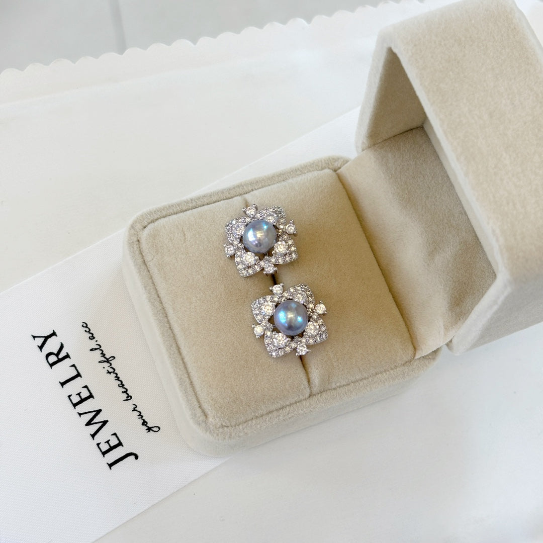 Elegant pearl jewelry set featuring four-leaf clover earrings, ring, and pendant with Akoya pearls and ice-crystal design.