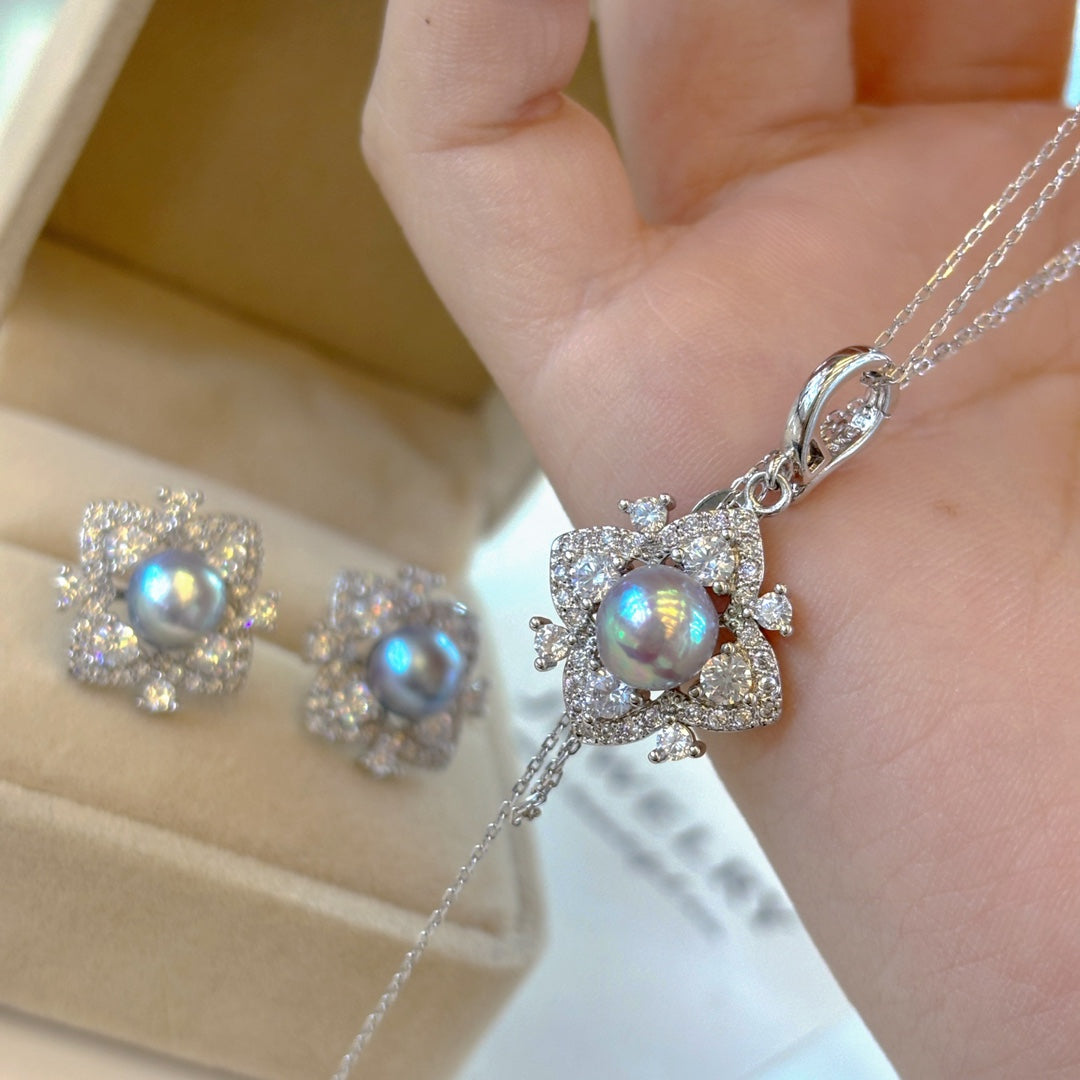 Elegant pearl jewelry set featuring four-leaf clover earrings, ring, and pendant with Akoya pearls and ice-crystal design.