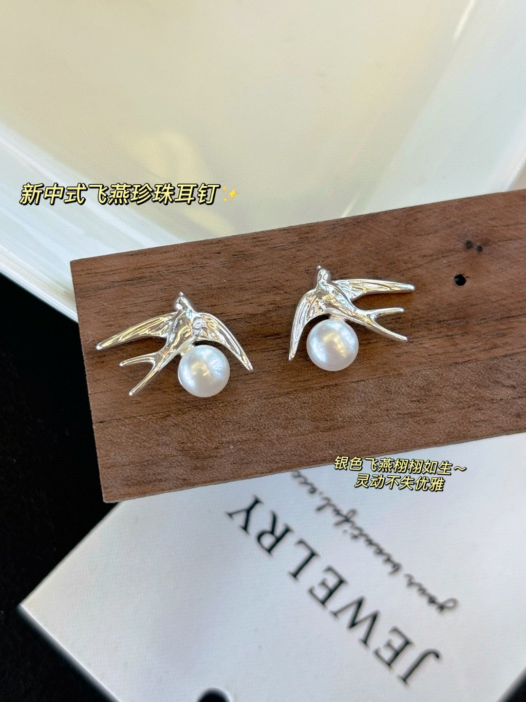 Silver swallow earrings with freshwater pearls by AnSes & Co.