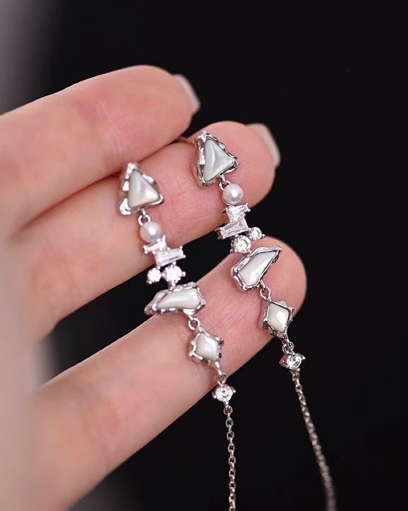 Glacier Cascade earrings with freshwater pearls, inspired by iceflow and cascading glacier forms.
