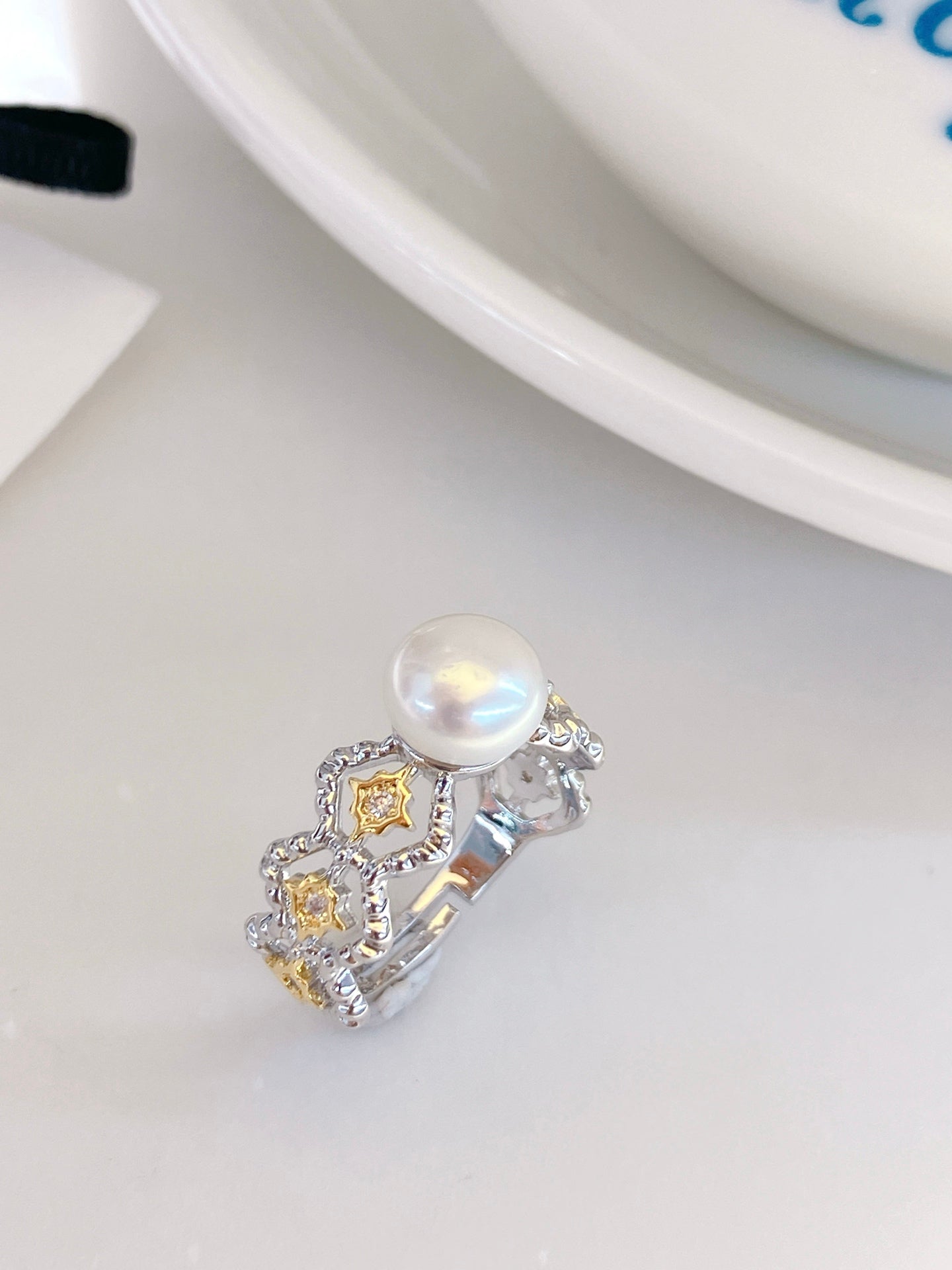 Adjustable gold open ring with geometric cut-out design and freshwater pearl
