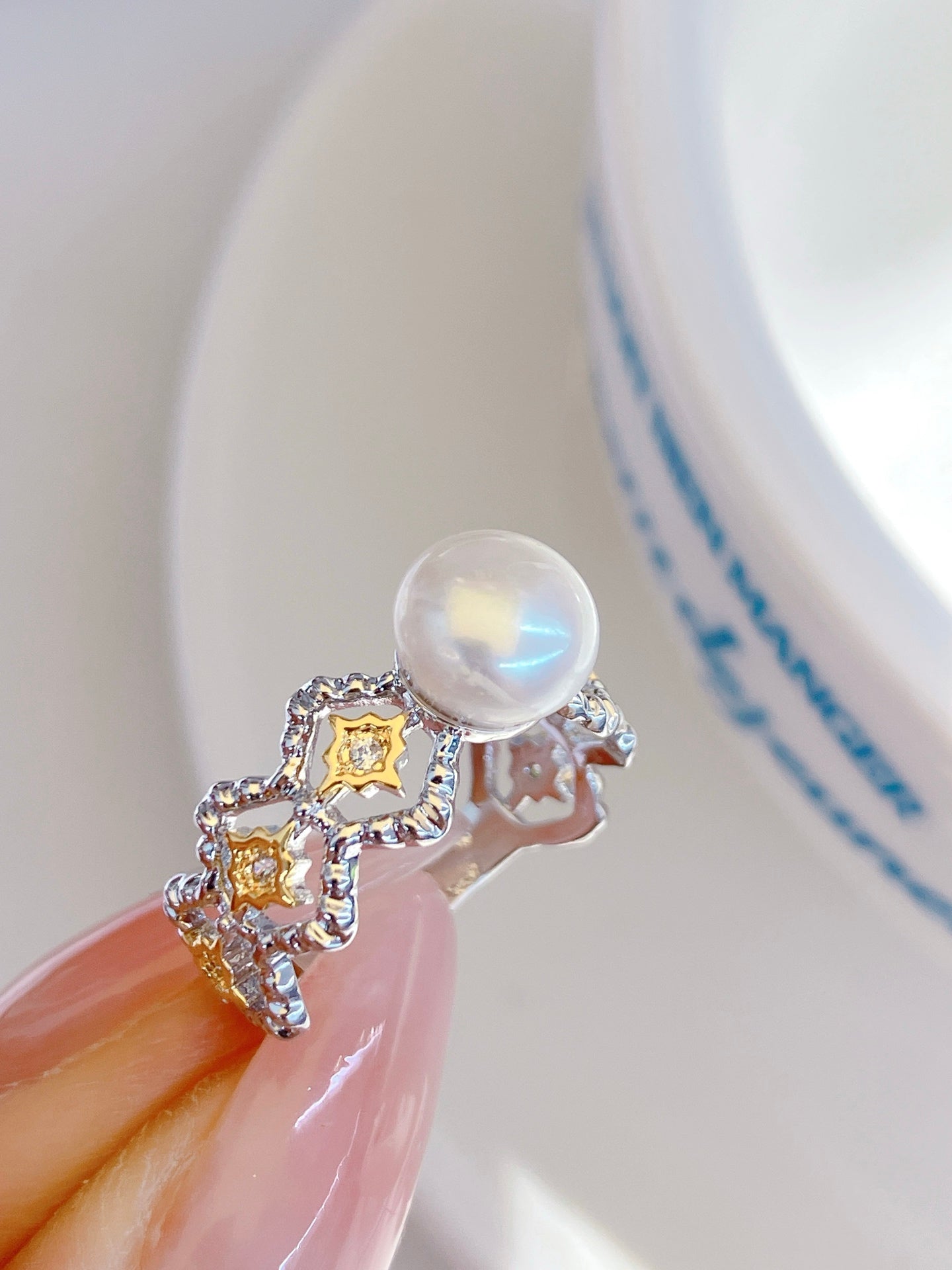 Adjustable gold open ring with geometric cut-out design and freshwater pearl
