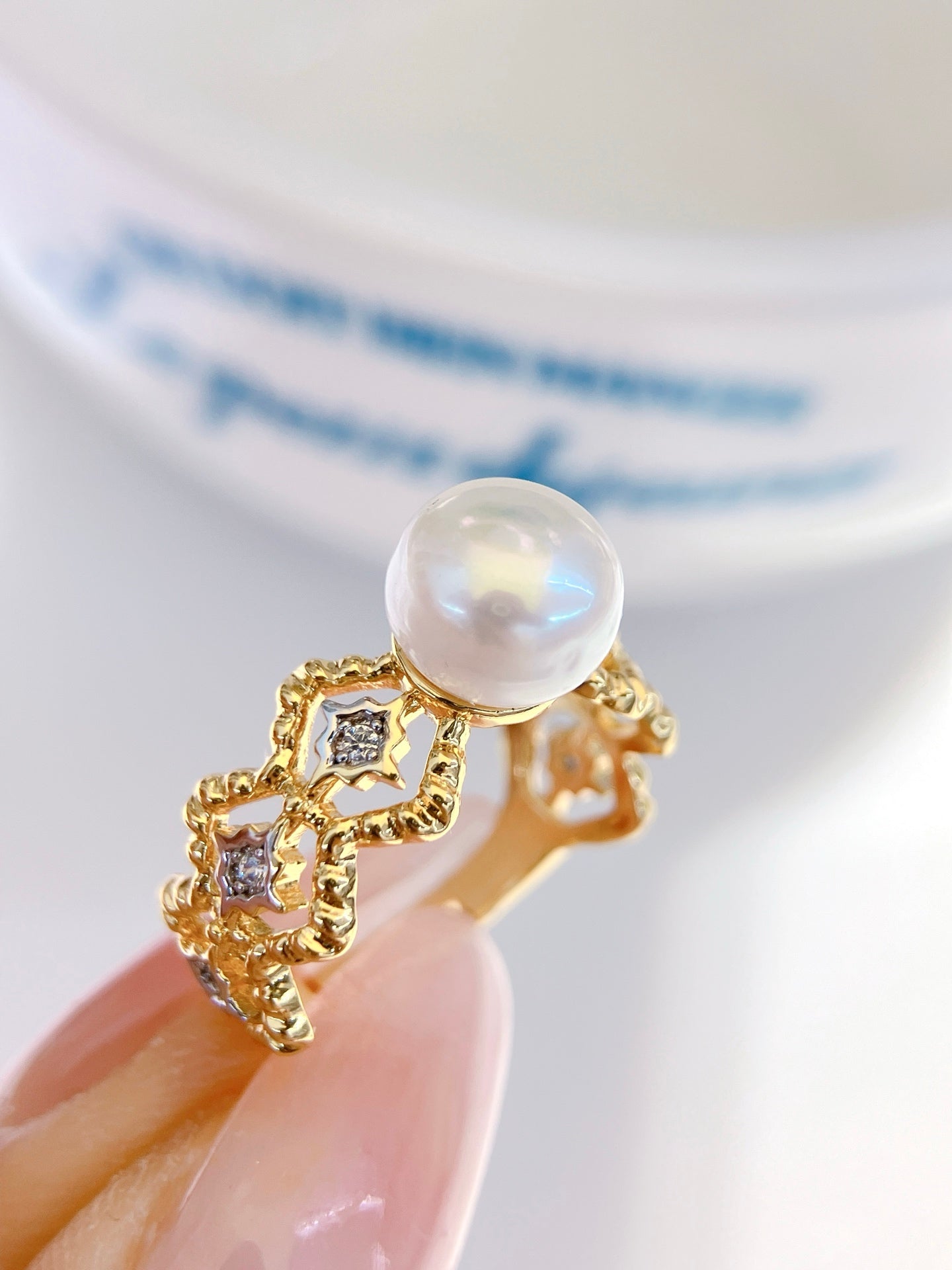 Adjustable gold open ring with geometric cut-out design and freshwater pearl