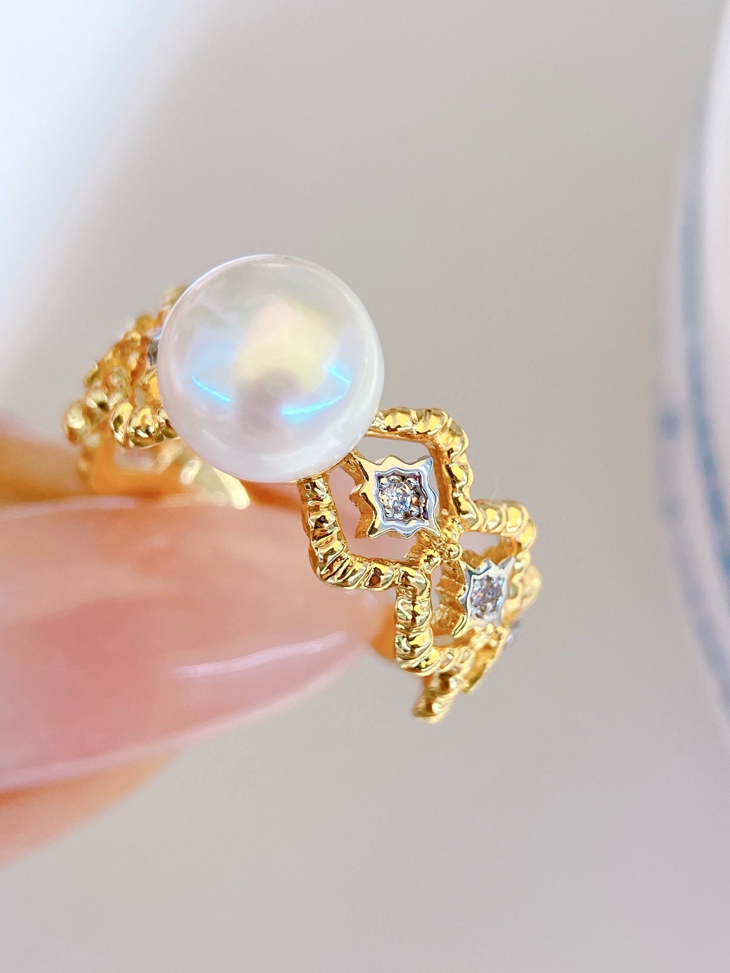Adjustable gold open ring with geometric cut-out design and freshwater pearl