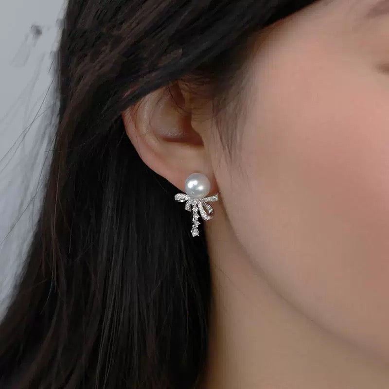 Model wearing silk ribbon bow pearl stud earrings
Close-up of freshwater pearl bow stud earrings