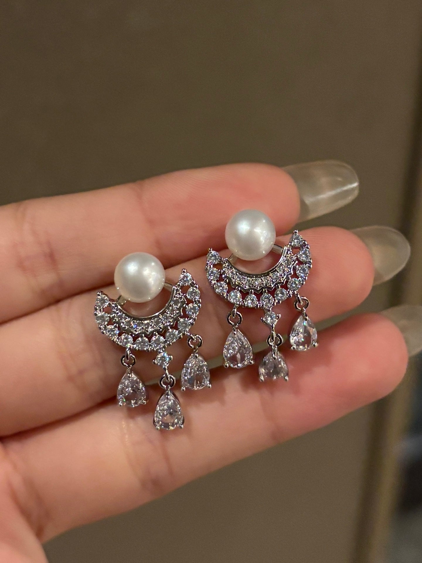 Shimmering tassel-style earrings with waterdrop pearls and sparkling zirconia on silver posts