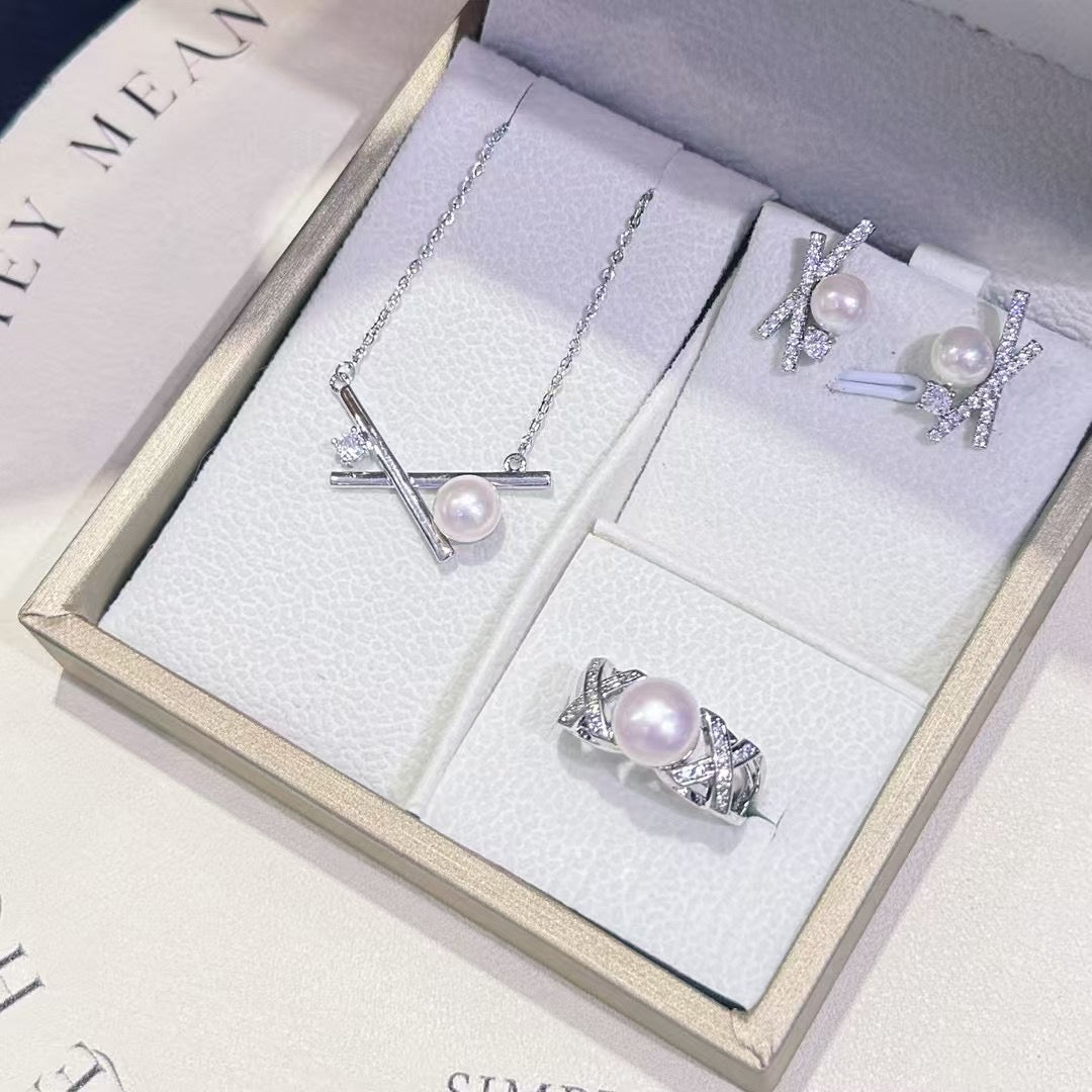 Three-piece pearl jewelry set with earrings, pendant, and ring in silver-tone 14k gold finish