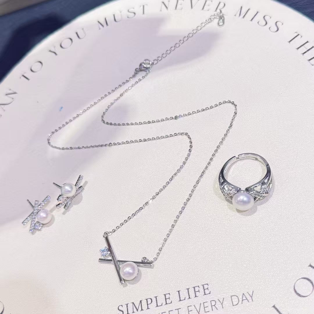 Three-piece pearl jewelry set with earrings, pendant, and ring in silver-tone 14k gold finish