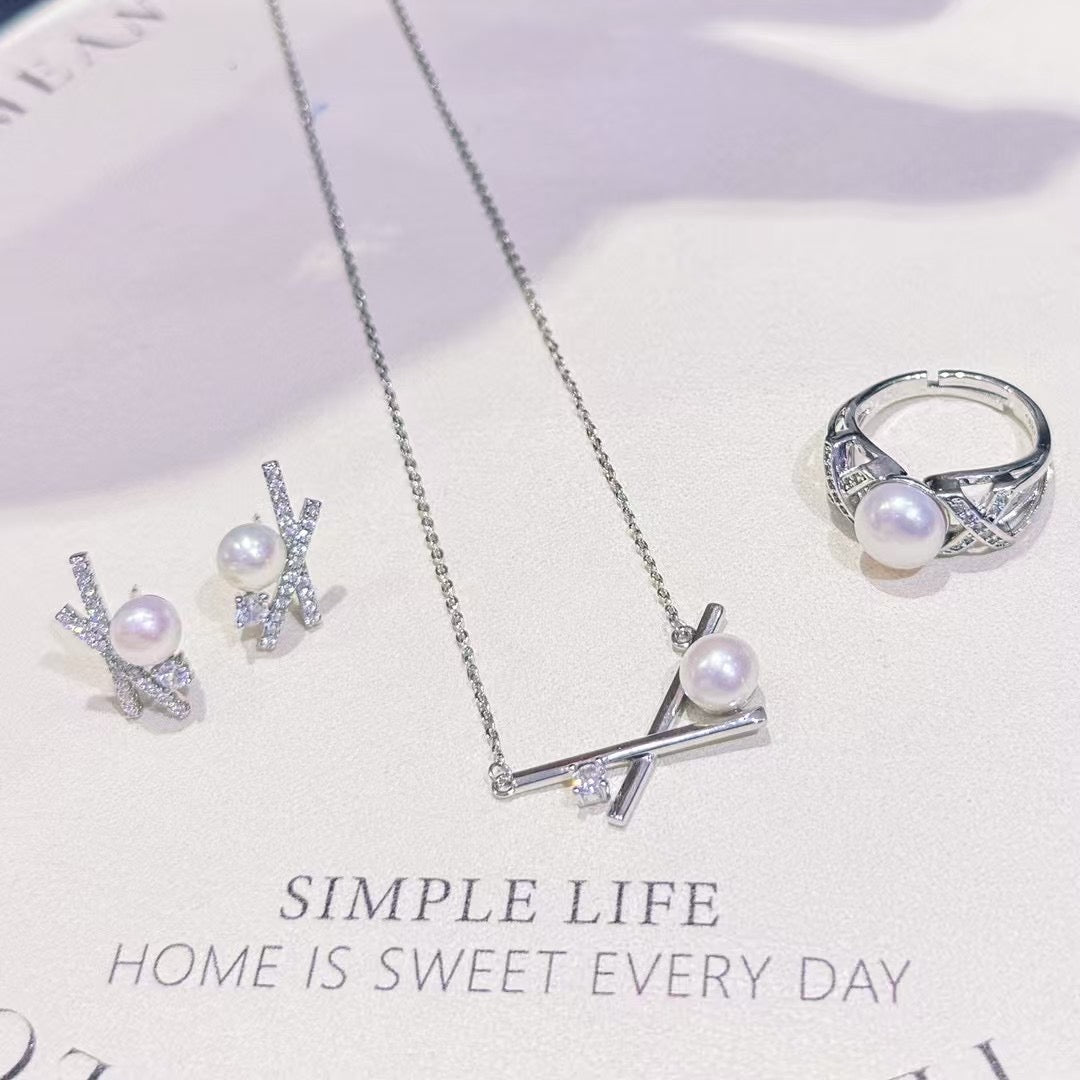 Three-piece pearl jewelry set with earrings, pendant, and ring in silver-tone 14k gold finish
