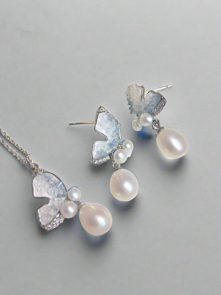Clear Blue Ice Butterfly jewelry set featuring freshwater pearls and butterfly accents on white background