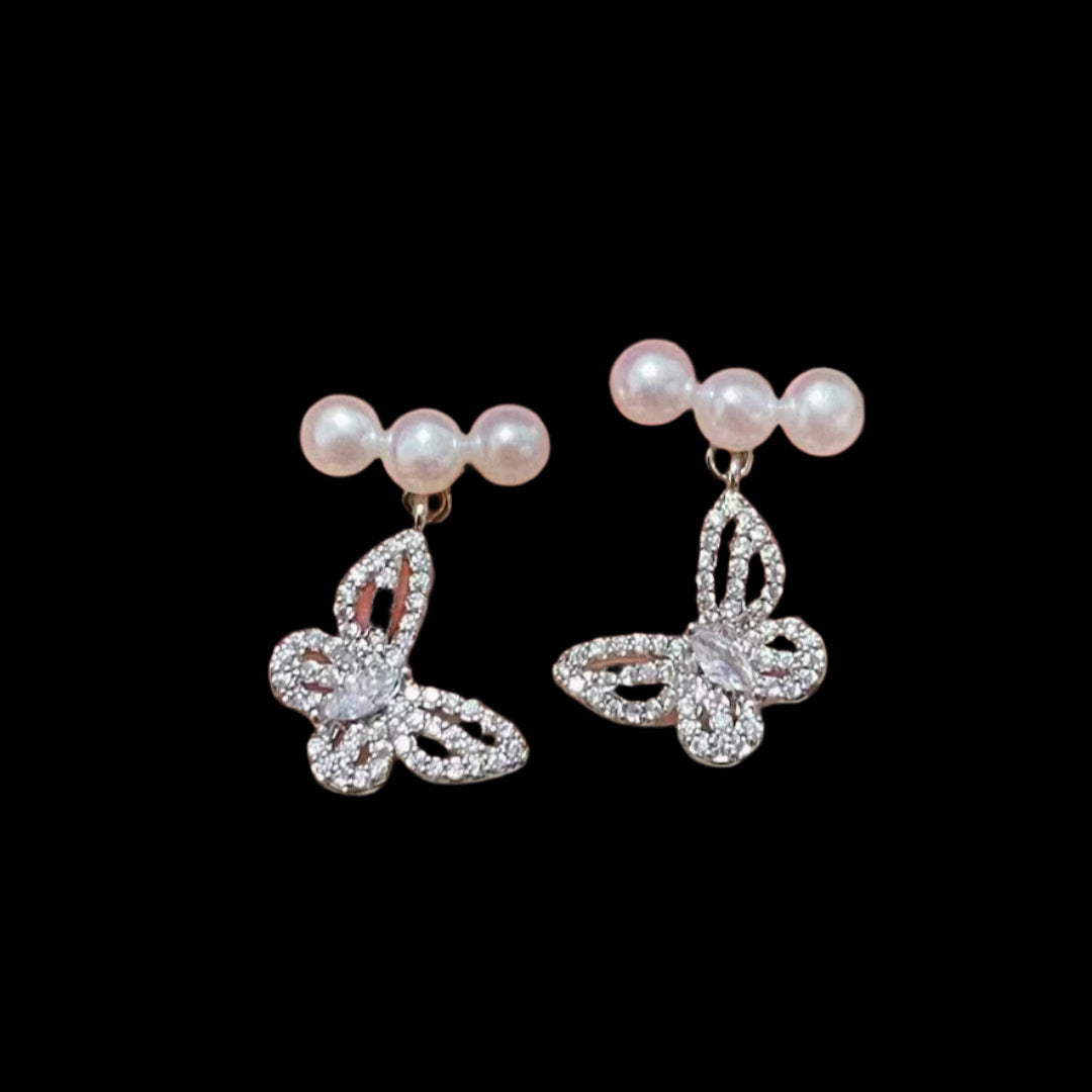 Close-up of butterfly design with centered pearl on 925 silver post