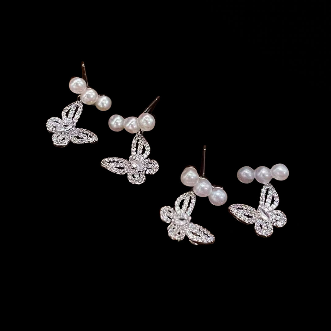 Butterfly pearl stud earrings with 4-5mm freshwater pearls on white background