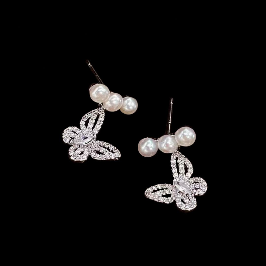 Close-up of butterfly design with centered pearl on 925 silver post