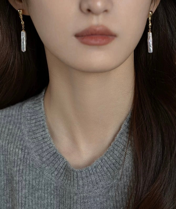 Model wearing French-inspired long pearl earrings