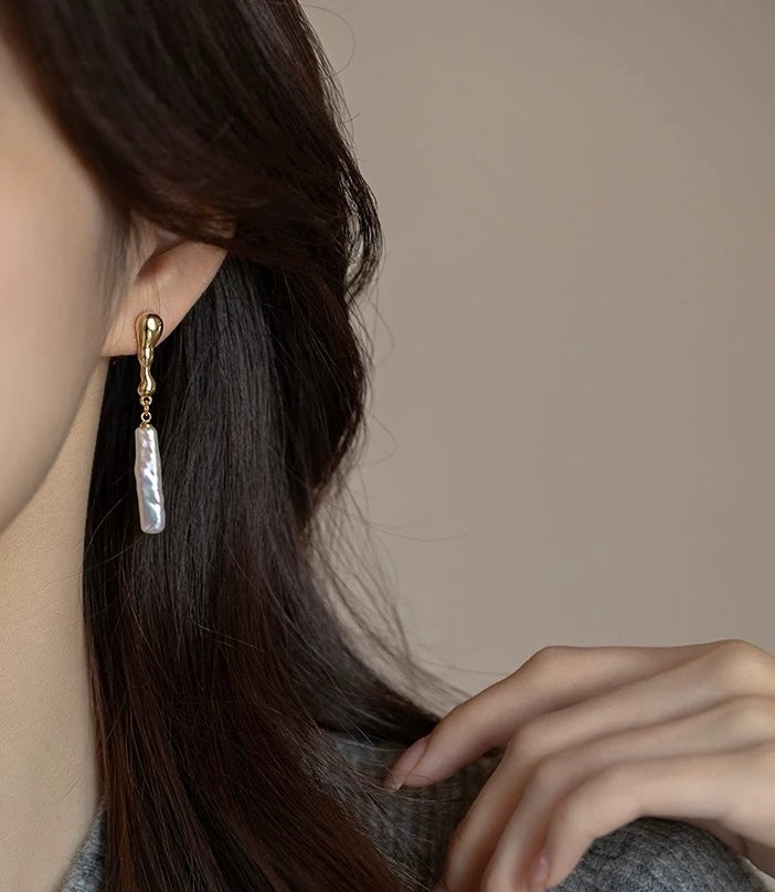 Model wearing French-inspired long pearl earrings