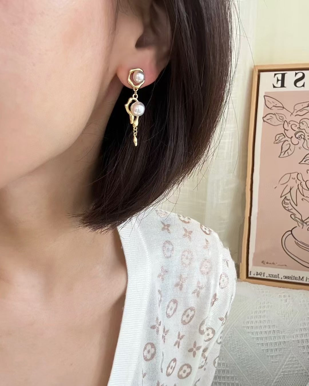 Model wearing sculptural molten pearl stud earrings