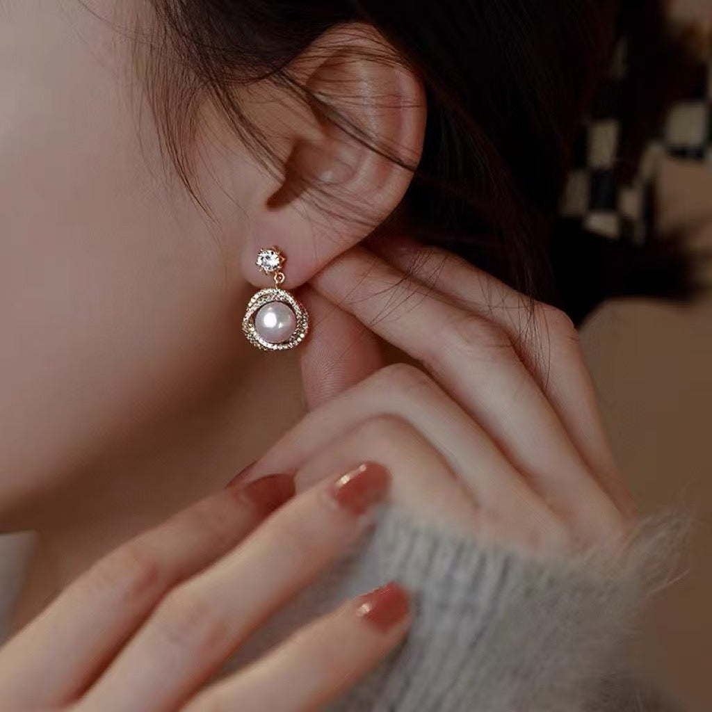 Model wearing glowing pearl studs from AnSes & Co.