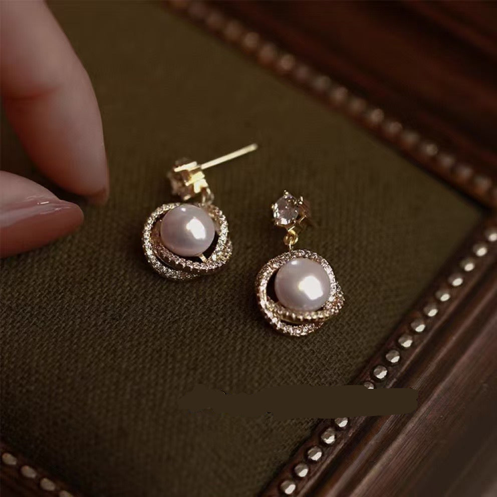 Close-up of high-luster pearl set on sterling silver post