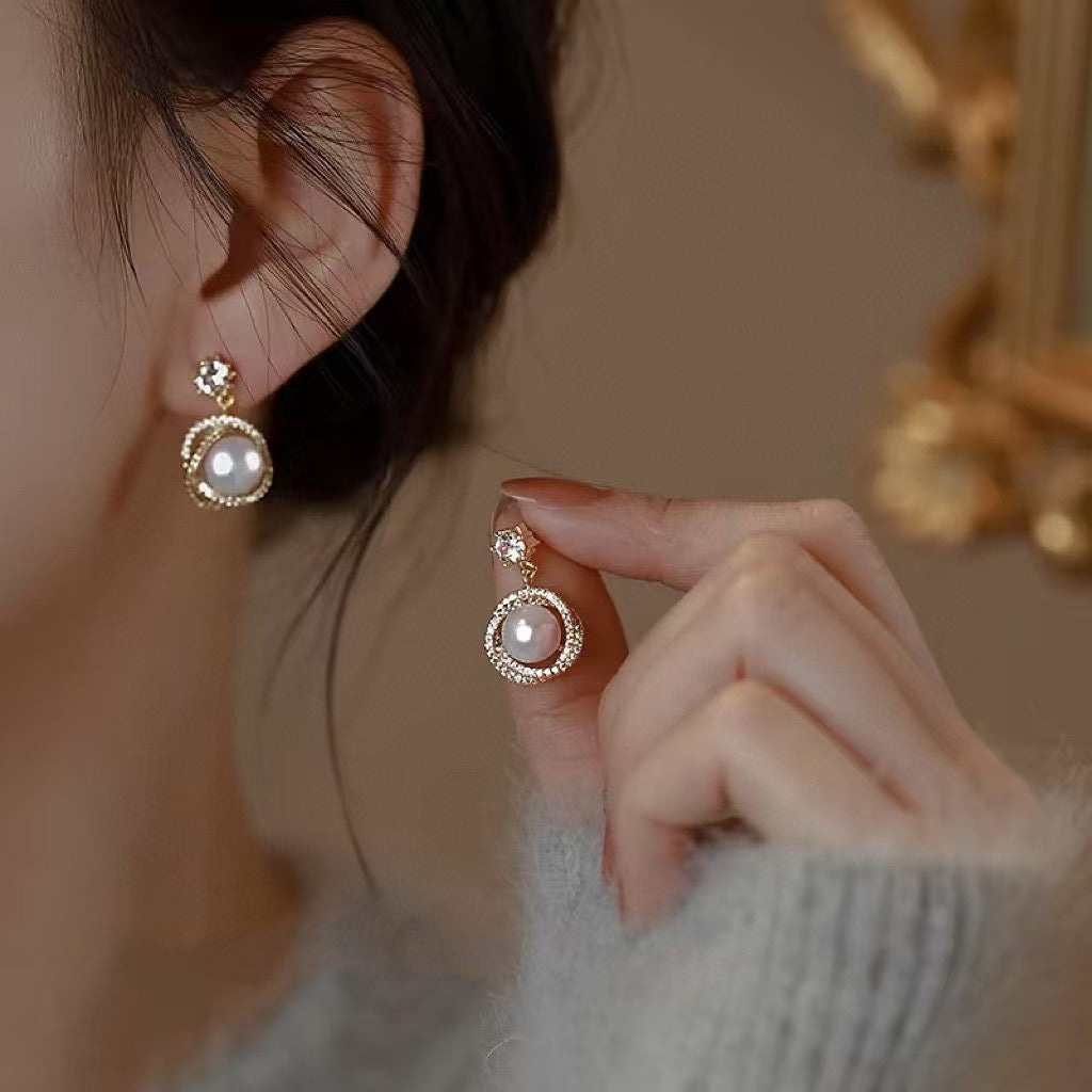 Model wearing glowing pearl studs from AnSes & Co.